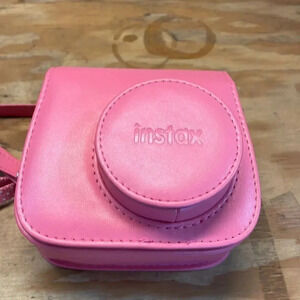 NWOT Instax pink camera. It only comes with the camera and case but no camera